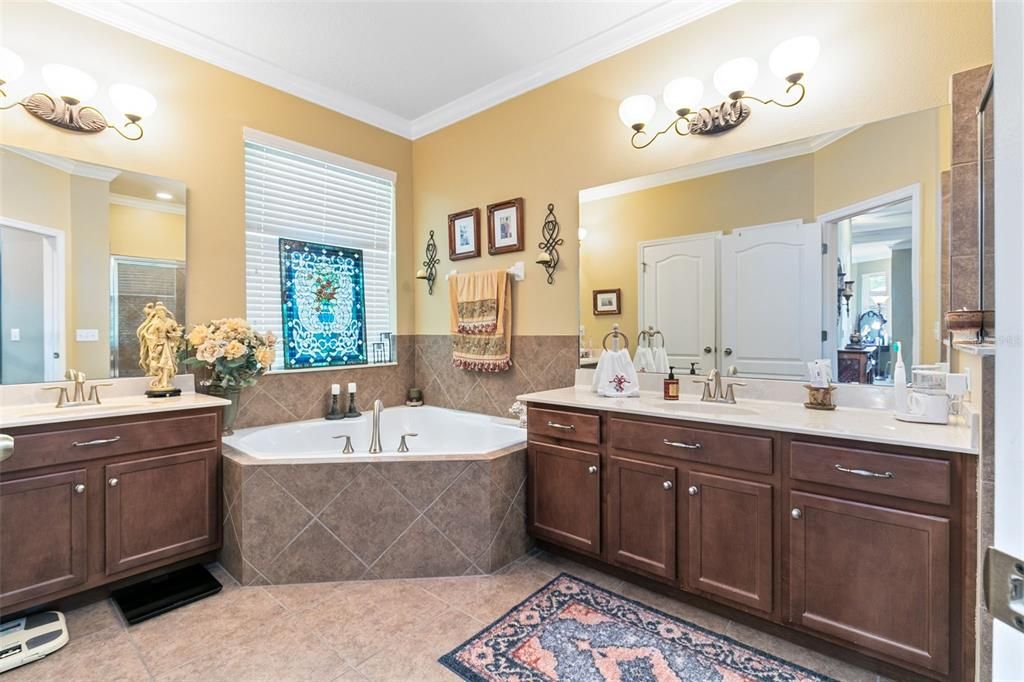 The master bath features two separate vanities and a garden tub.