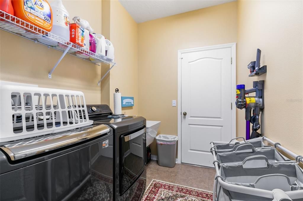 Laundry room with a sink and access to the 3 car garage.