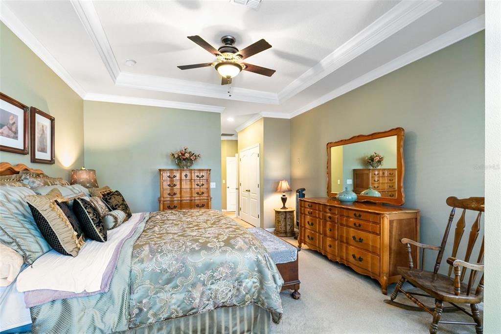 A tray ceiling and crown molding add a touch of traditional charm.