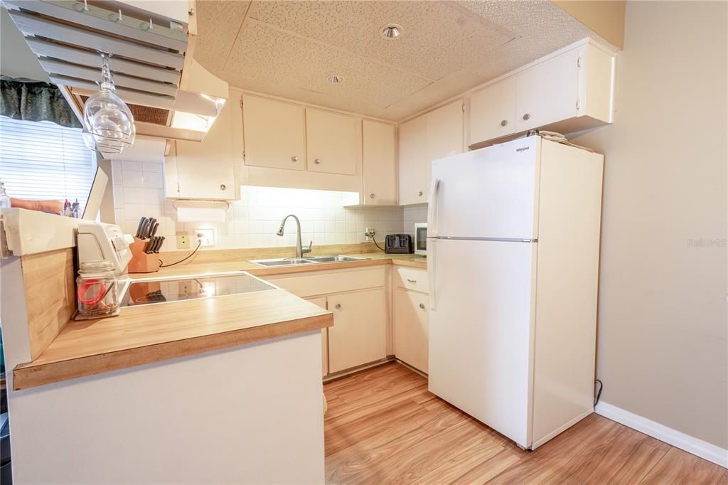 The kitchen is light and inviting, with plenty of cabinet and storage space.