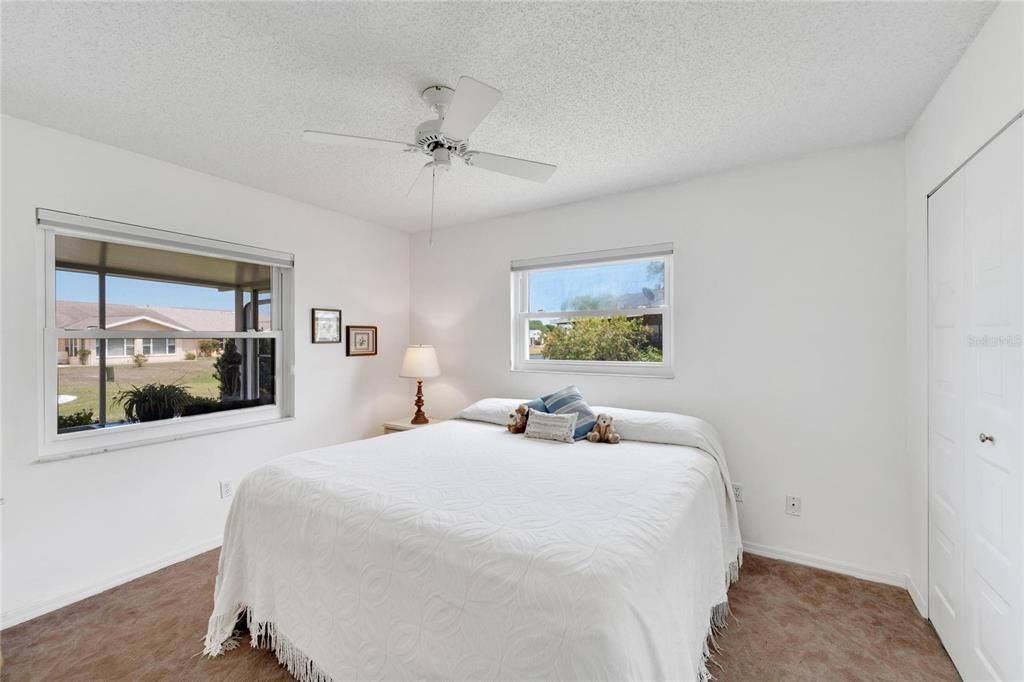 comfortably sized bedroom overlooking lanai and yard