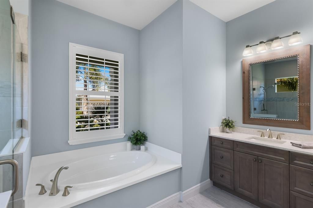 Primary bathroom with dual vanities, soaking tub and shower