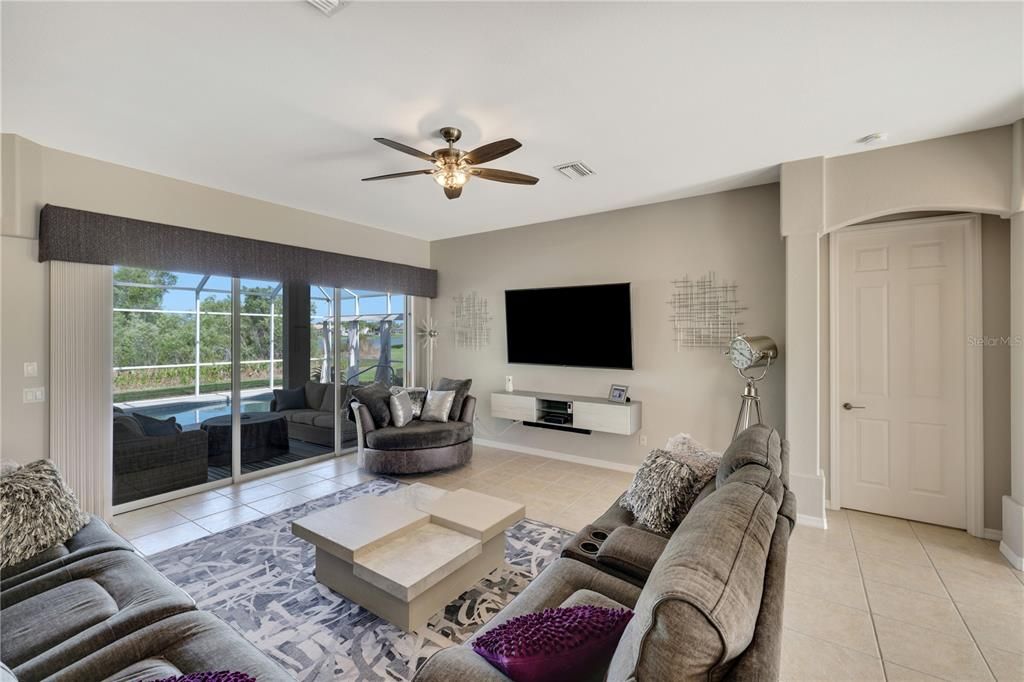 Spacious Living room.... Sliding glass doors out to the lanai/pool.  Tv on wall included.....