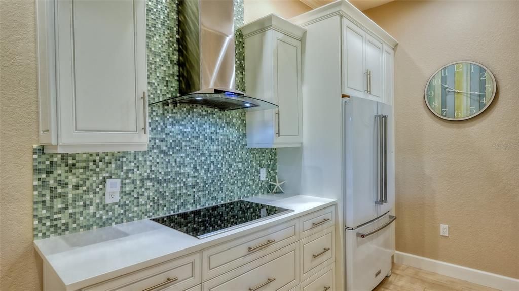 Glass tile enhances the kitchen wall.