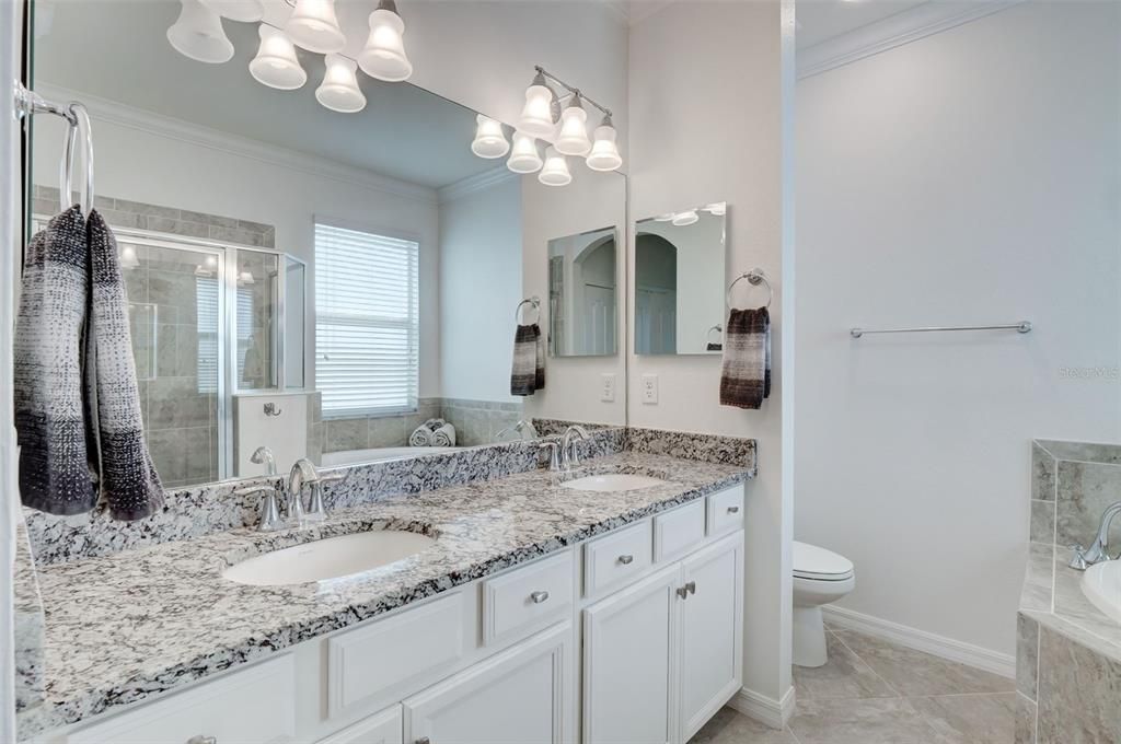 Owner's bath with white cabinetry