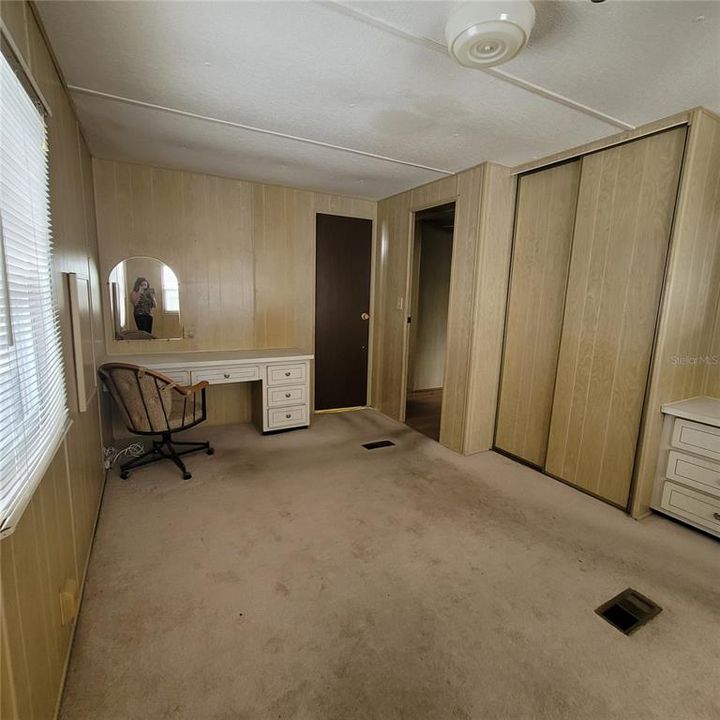 Large Primary Bedroom with built in closets, dresser and vanity/desk
