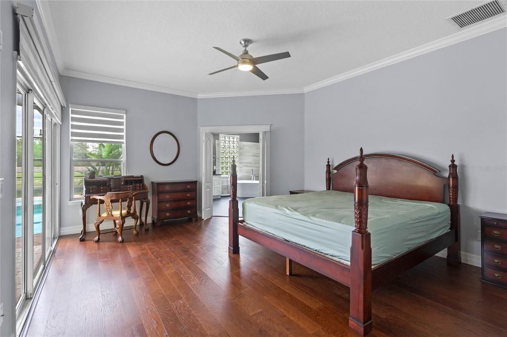 The master bedroom features motorized shades, double door entry and hard wood floors.