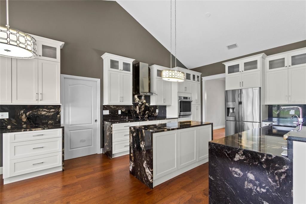 The kitchen features extra tall solid wood cabinets with an incredible amount of storage options.