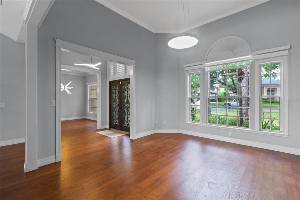 View of the formal living area overlooking a quiet mature tree lined street.