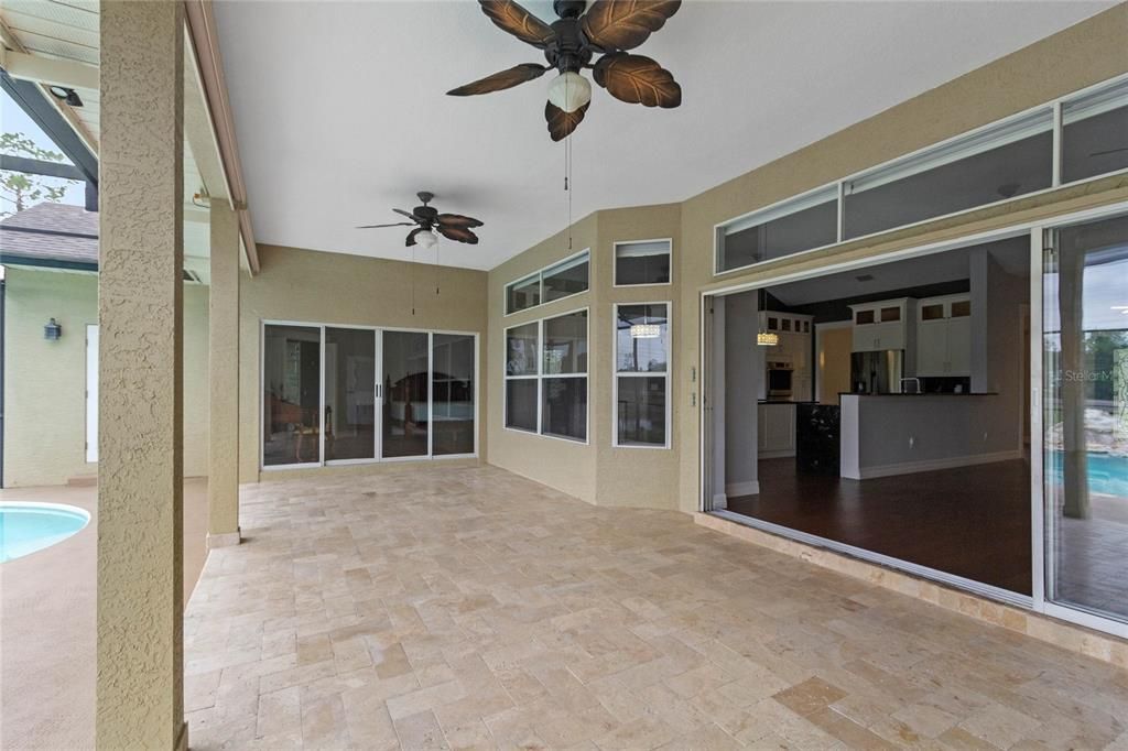 The pool deck features a covered lanai perfect for entertaining in any weather