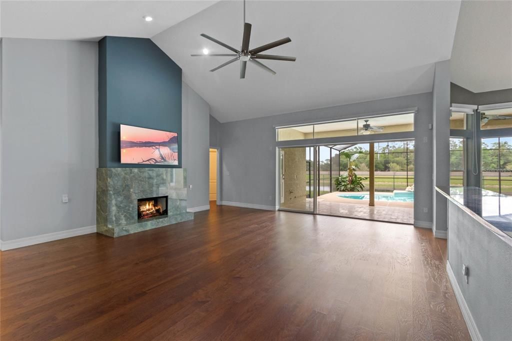 The family room is perfect for entertaining with a large triple slider that opens onto the expansive pool deck.