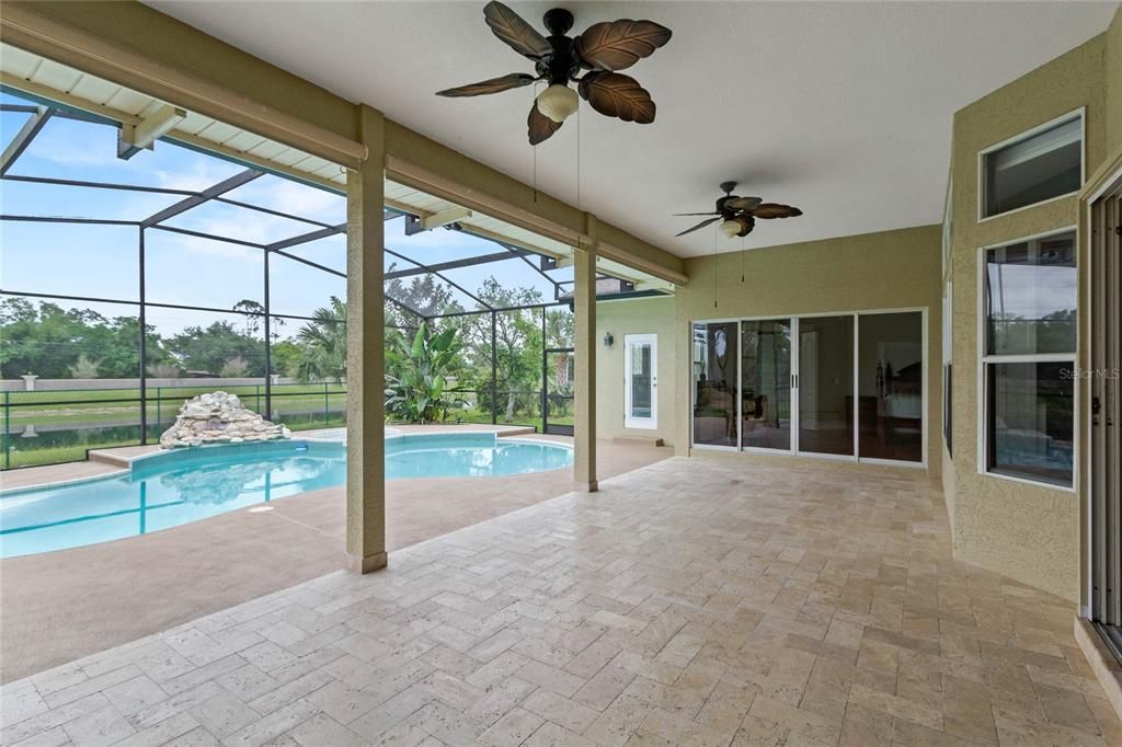 The pool deck features a covered lanai perfect for entertaining in any weather