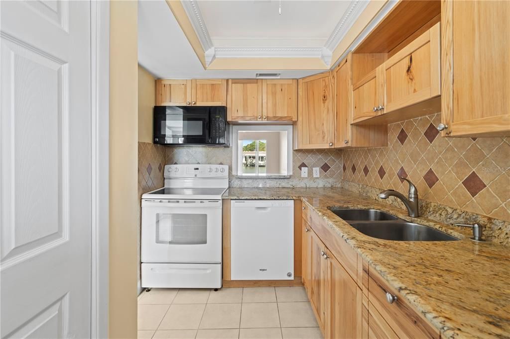 Very nice stone counters and wood cabinetry