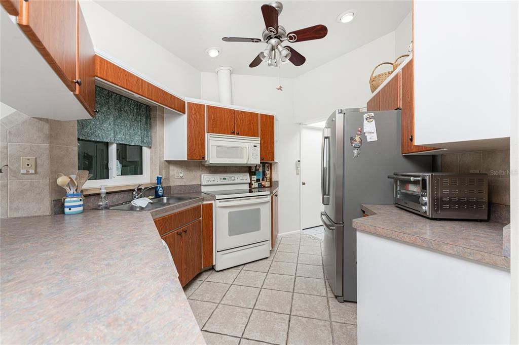 Galley kitchen has ample cabinetry and countertop area!