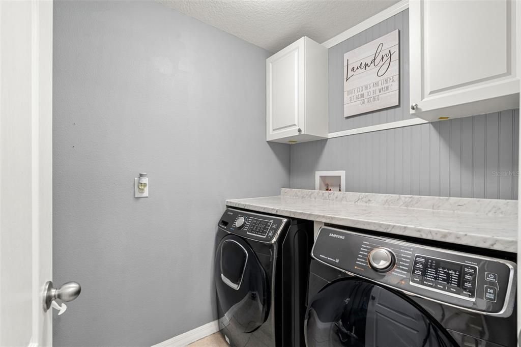 Laundry room with counter top and cabinets