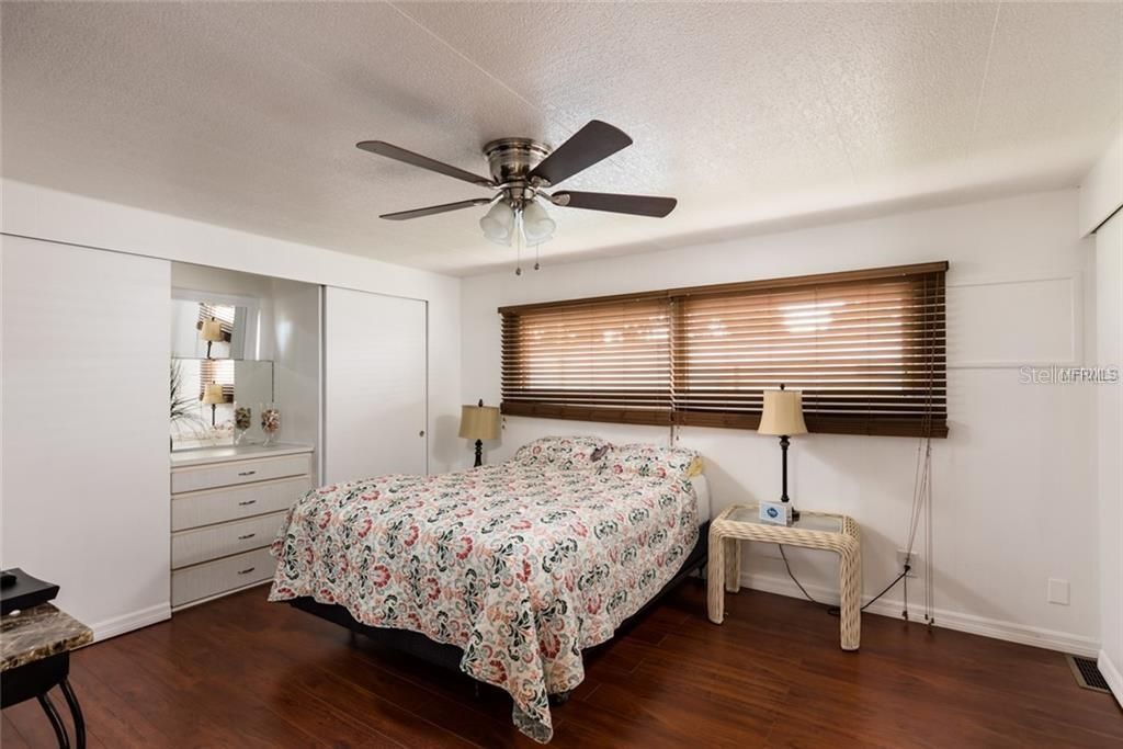 The spacious master bedroom features multiple closets
