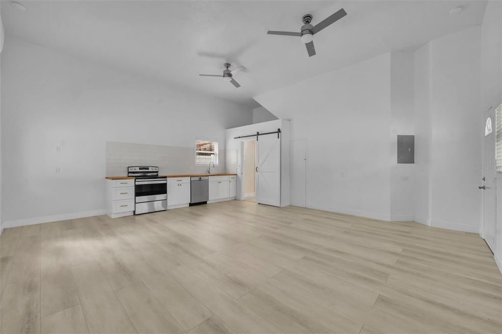 Oversized converted garage studio apartment is naturally bright and airy and comes with an Amana Range and Bosch diswasher already in place.
