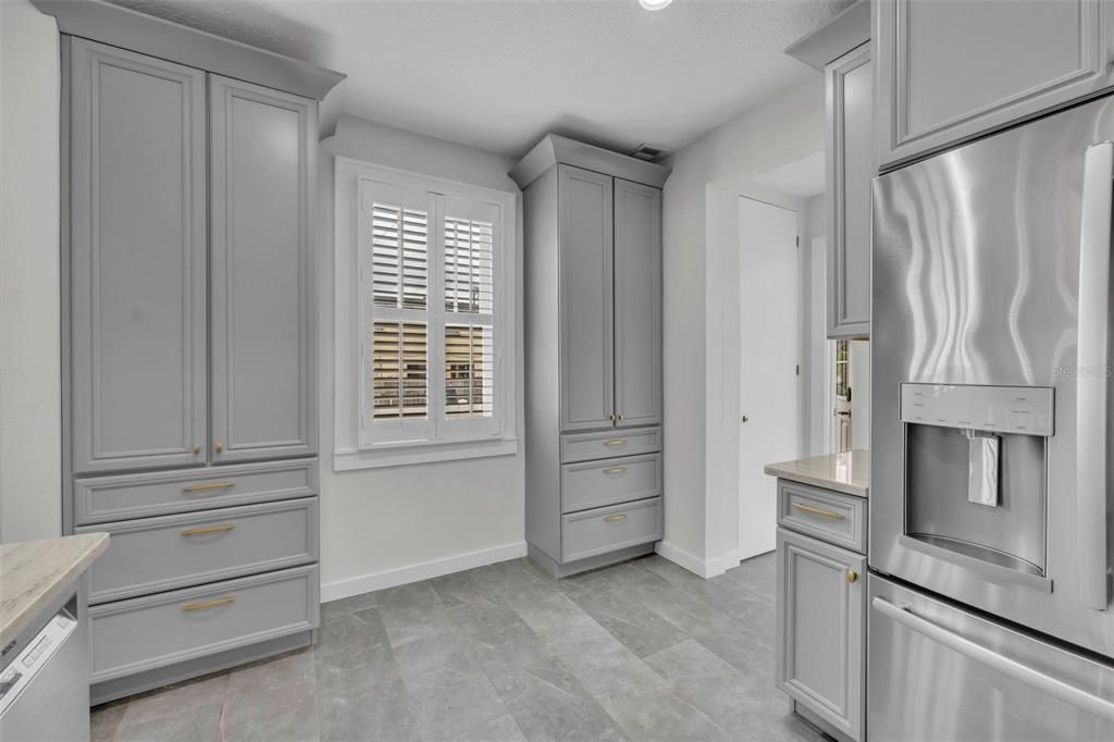 Oversized dual pantry cabinets add to the floor to ceiling original pantry's storage prowess.
