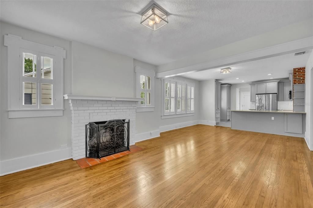 Expansive, original hardwood floors connect living and dining areas.