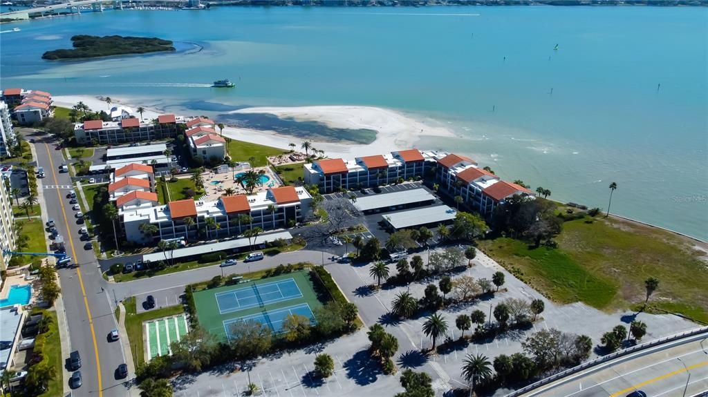 Aerial View of low rise buildings, tennis courts, and shuffleboard of Clearwater Point.