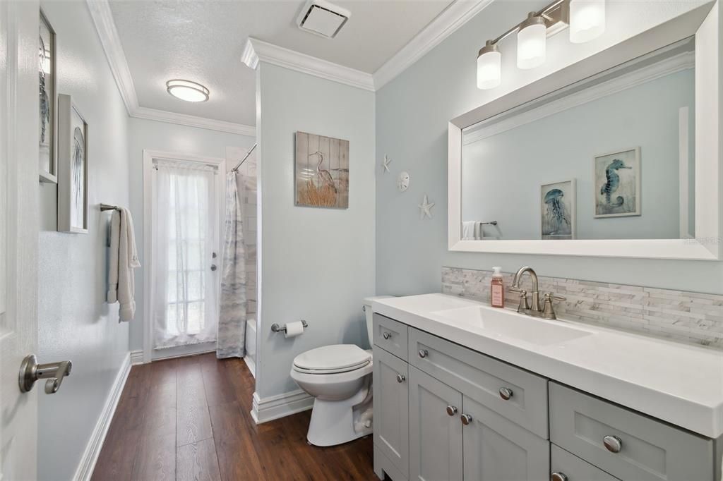 beautifully remodeled bathroom with door to patio area
