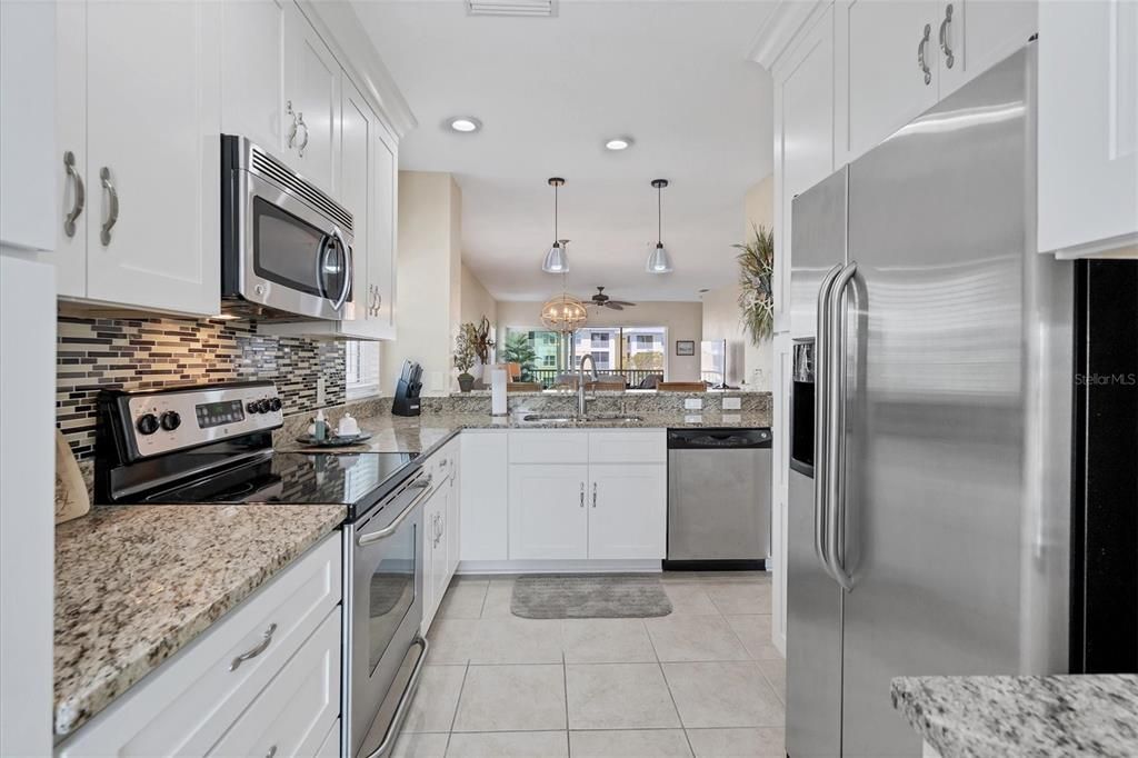 Magnificantly updated kitchen with soft close cabinetry, granite & decorative tiled backsplash