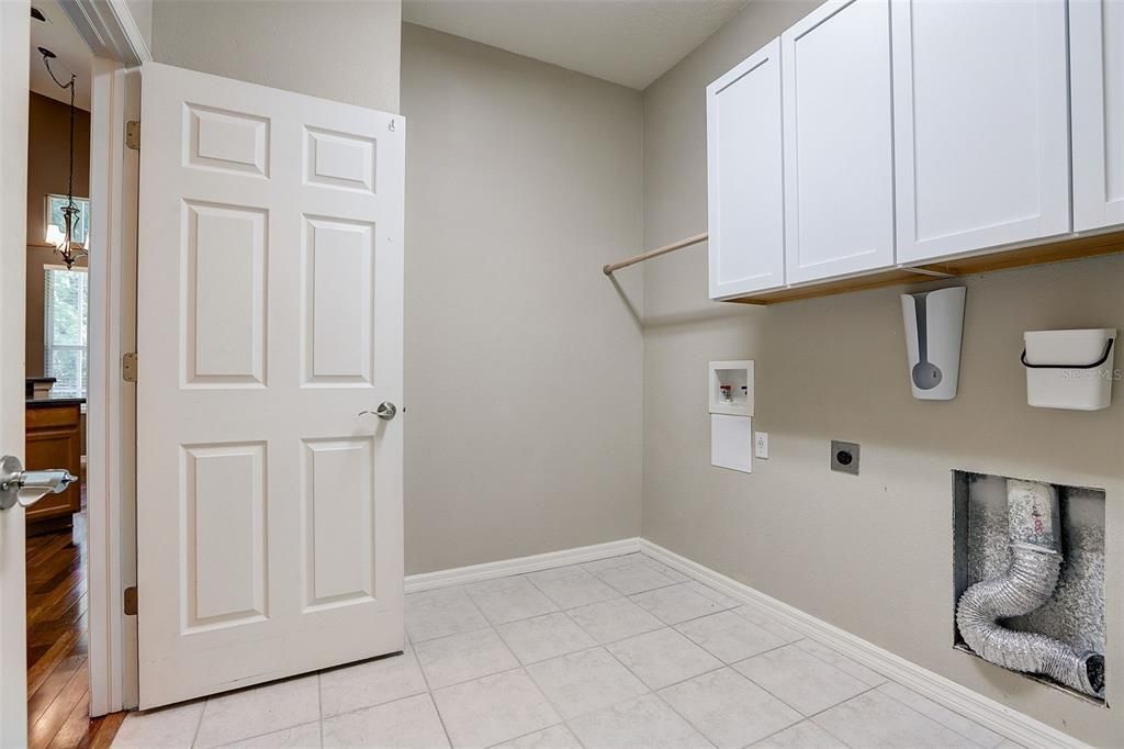 Laundry room with ample storage.