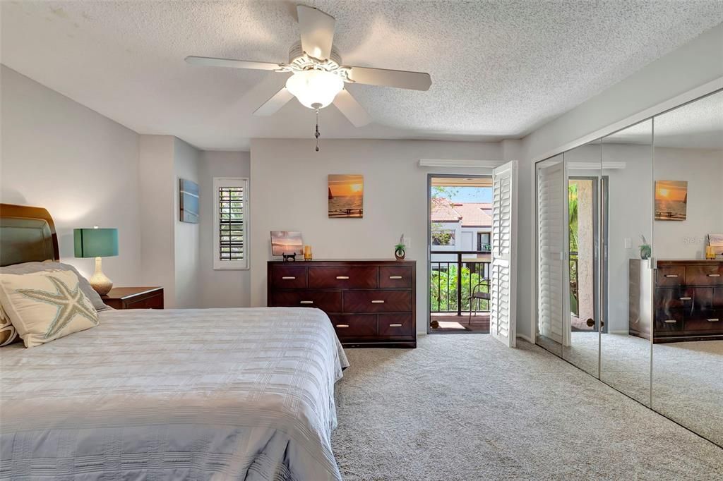 The master bedroom is large with mirrored closets and it's own balcony.