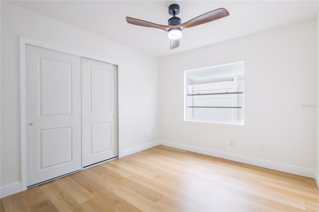 Bedroom # 3  11'x10' with a built-in closet and stylish ceiling fan.