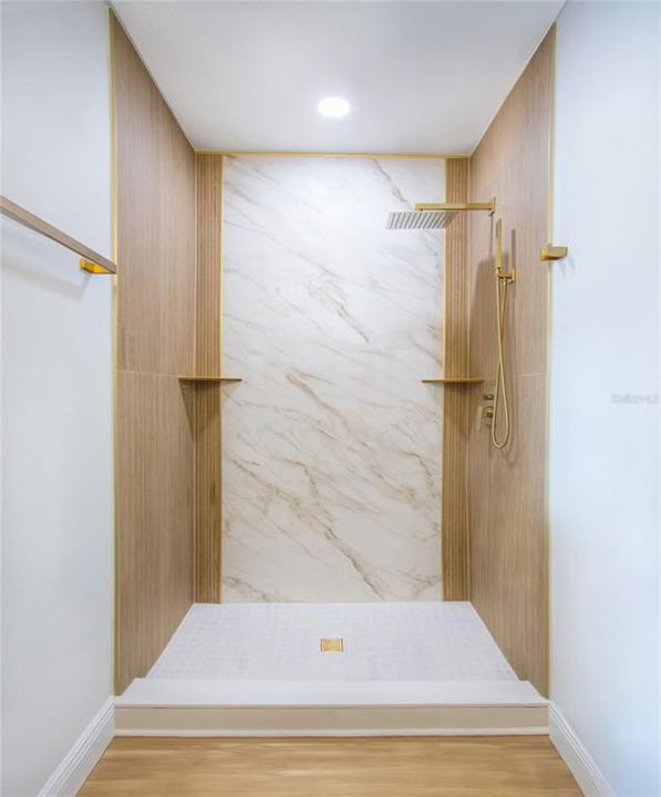 Wood ceramic tile, complemented by a modern gold shower faucet set featuring a RAIN FALL shower head and handheld.