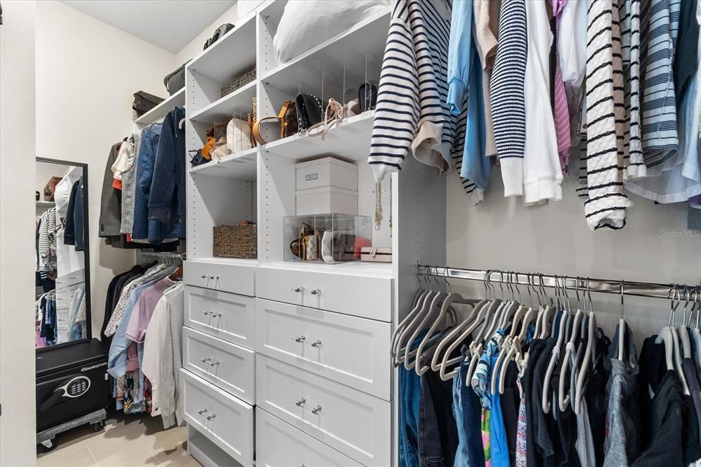 Primary closet with upgraded closet system.