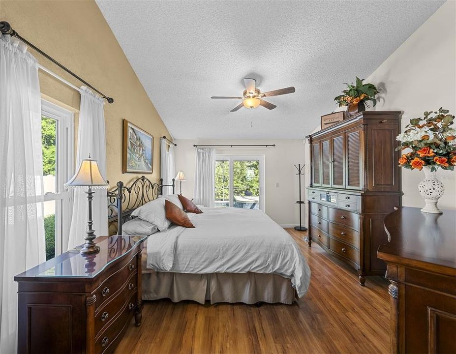 Wake up to a view of conservation and water from this spacious master bedroom.