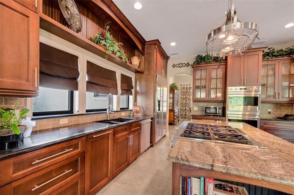 The kitchen is surrounded with stunning solid wood cabinetry. Floor to ceiling storage along with a walk-in pantry and , again ...two islands.