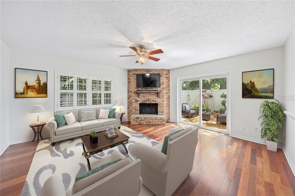 Florida room with wood burning fireplace virtually staged.