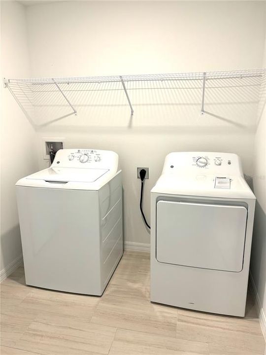 washer and dryer included in a laundry room