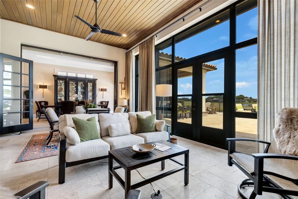 Tongue & groove wood ceiling and travertine flooring.