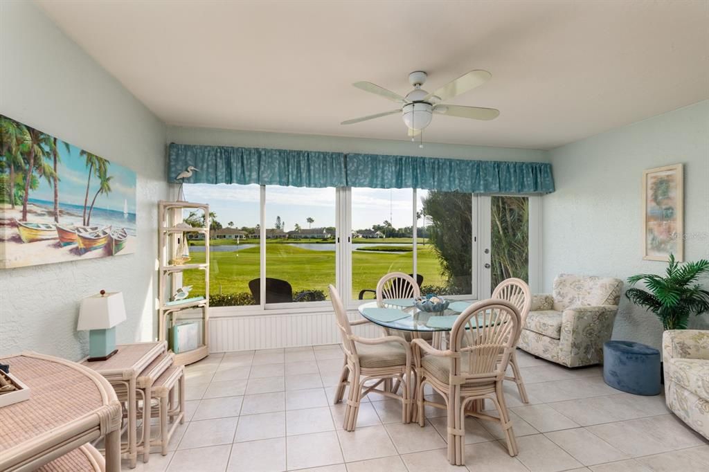 Florida Room w/views of 16th green on golf course & lake.