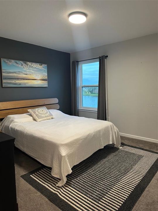 upstairs guest bedroom with queen sized bed/water view
