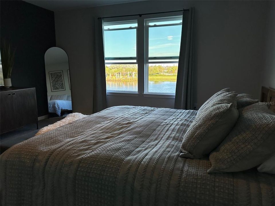 upstairs main bedroom with expansive water view/view of clubhouse area