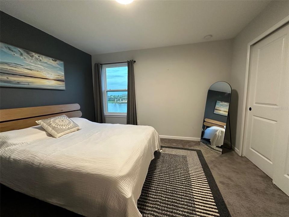 upstairs guest bedroom with queen sized bed/water view