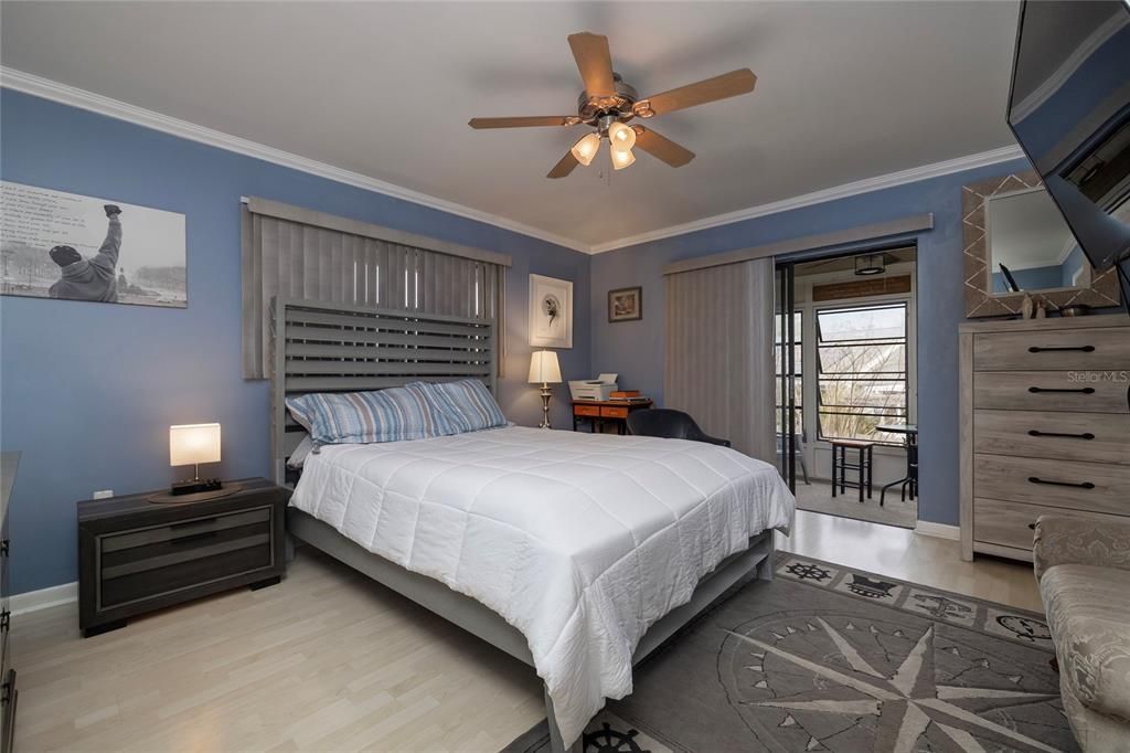 Primary Bedroom with walk in closet and sliders to the enclosed porch