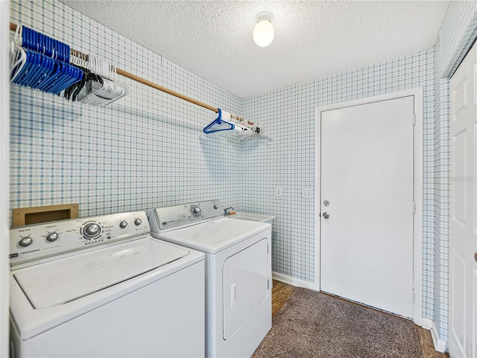 Inside laundry room is located off the kitchen and can be closed off with a pocket door.  The door in the picture leads to the two-car garage.