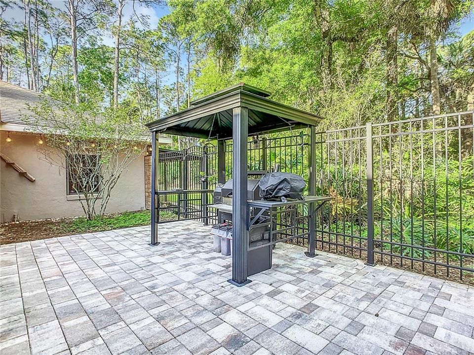 Covered BBQ area opens to rest of yard