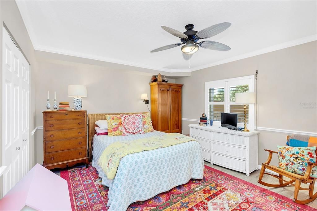 Virtually staged with neutral paint color secondary bedroom