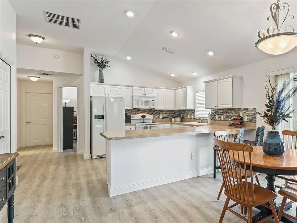 LARGE KITCHEN WITH BREAKFAST BAR, LOADS OF CABINETS (WITH PULL OUTS), CLOSET PANTRY