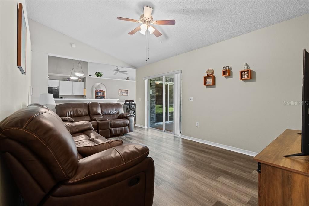 Family room with laminate wood like floors , flows into the kitchen and additional bedrooms