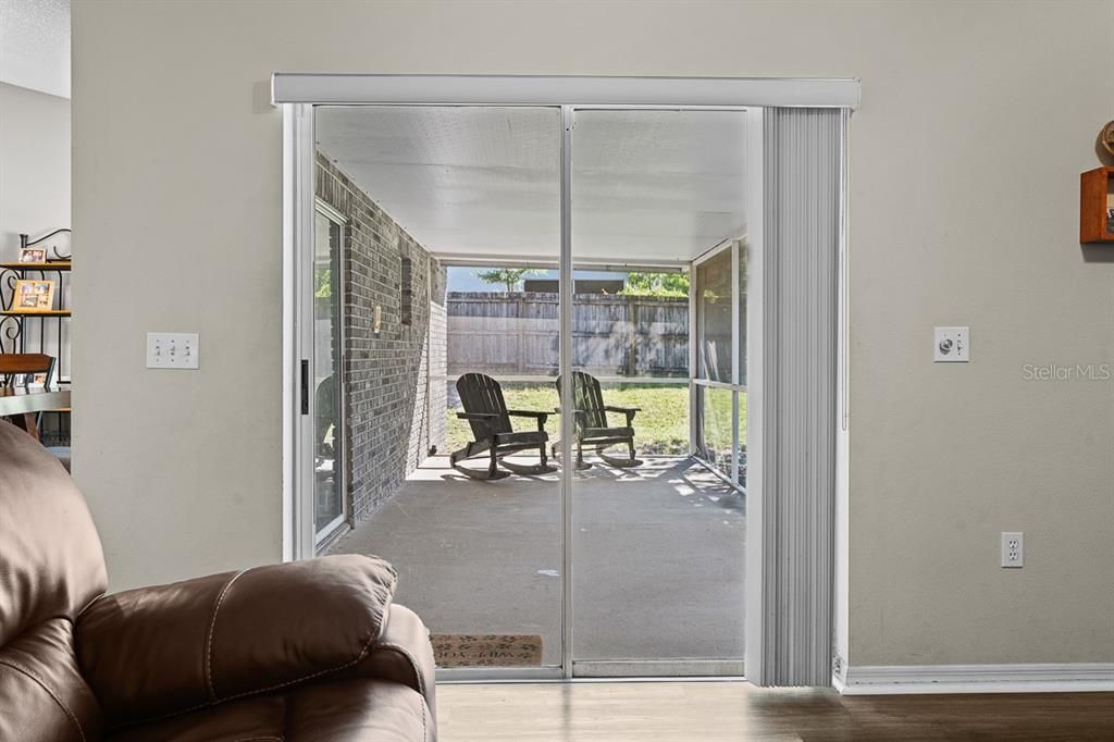 Glass sliding doors leading from the family room to the private, rear, screened porch.