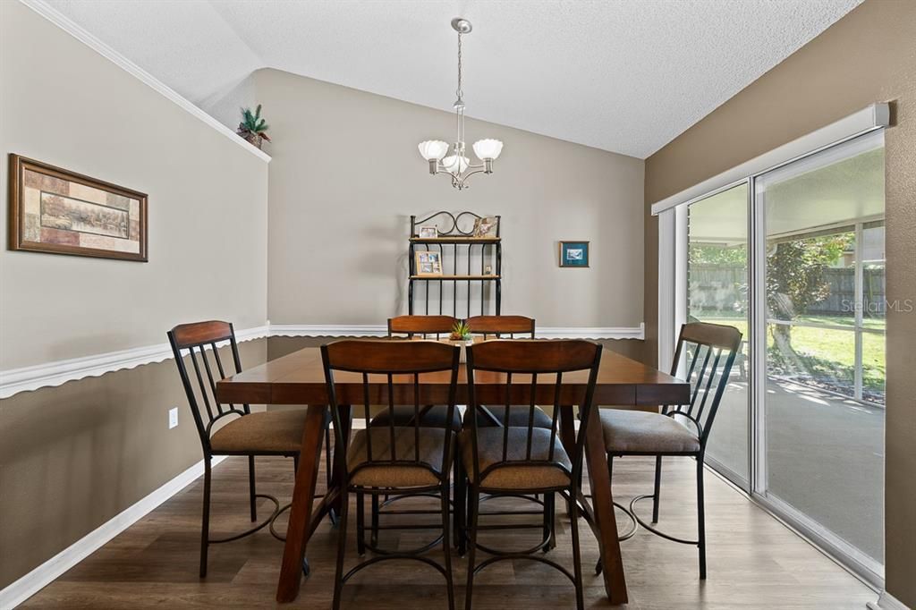 The dining area overlooks the private screened porch and fenced back yard.