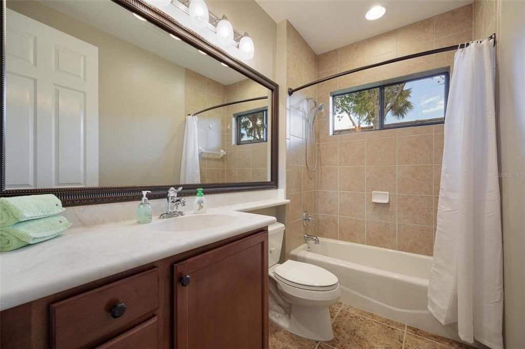 Guest Bathroom is located off the Kitchen and off the hallway between Bedrooms 2 & 3.