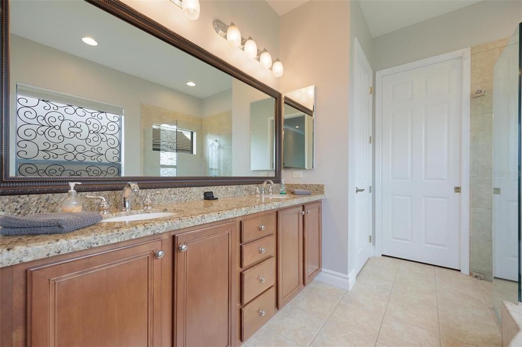 Luxurious double sink vanity separate tub and walk in shower. Private commode, and access to the walk in closet.